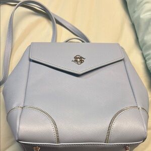 Blue Backpack with Structured Design and Metallic Closure